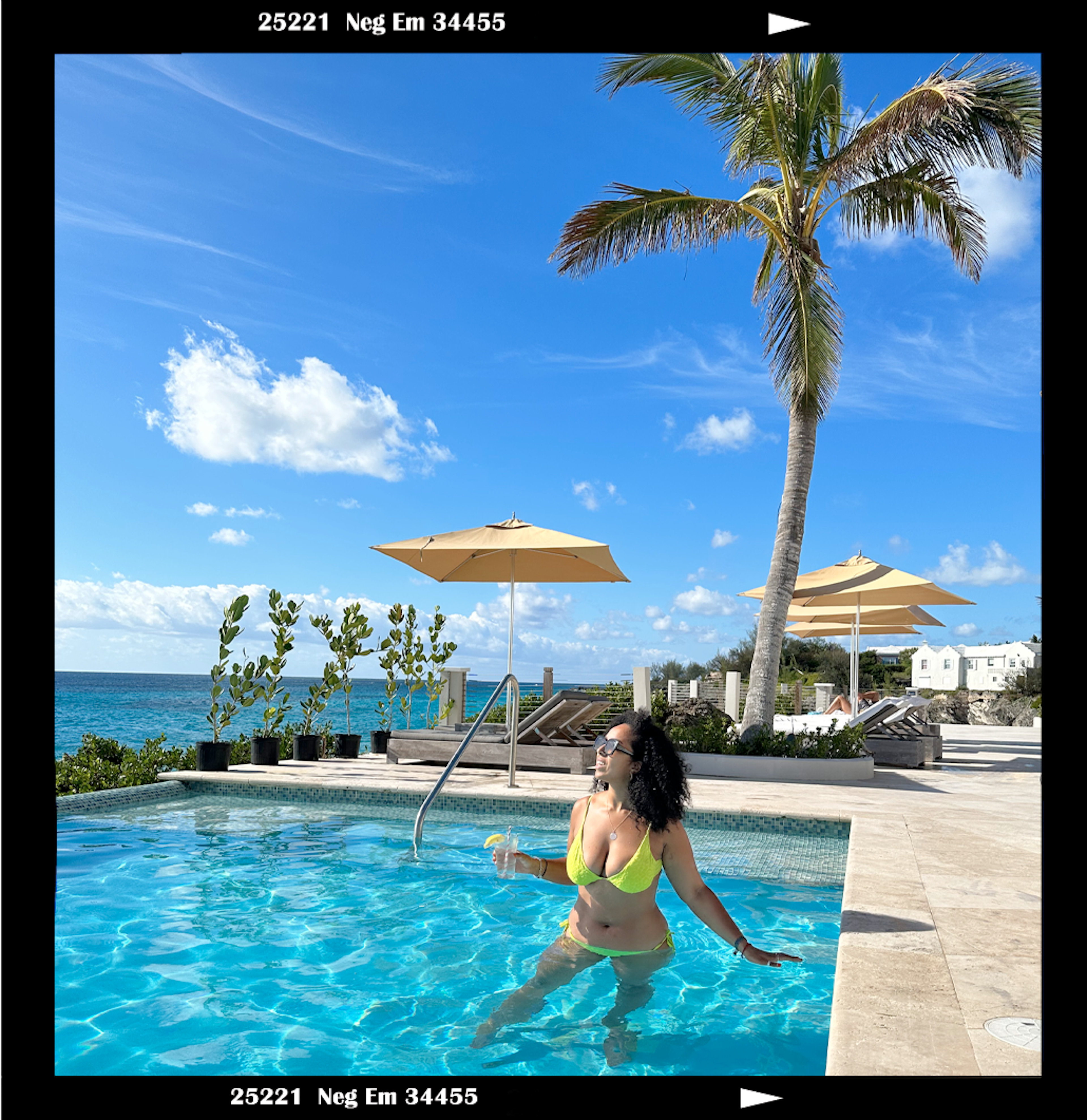 Author Georgina in a Bermuda swimming pool with a cocktail in her hand