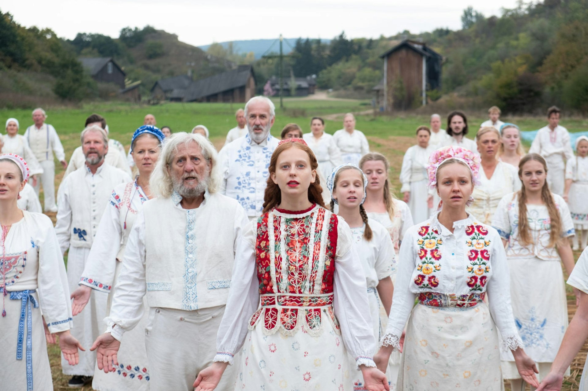 A still of actors in traditional Swedish folk costumes from the film “Midsommar” (2019)