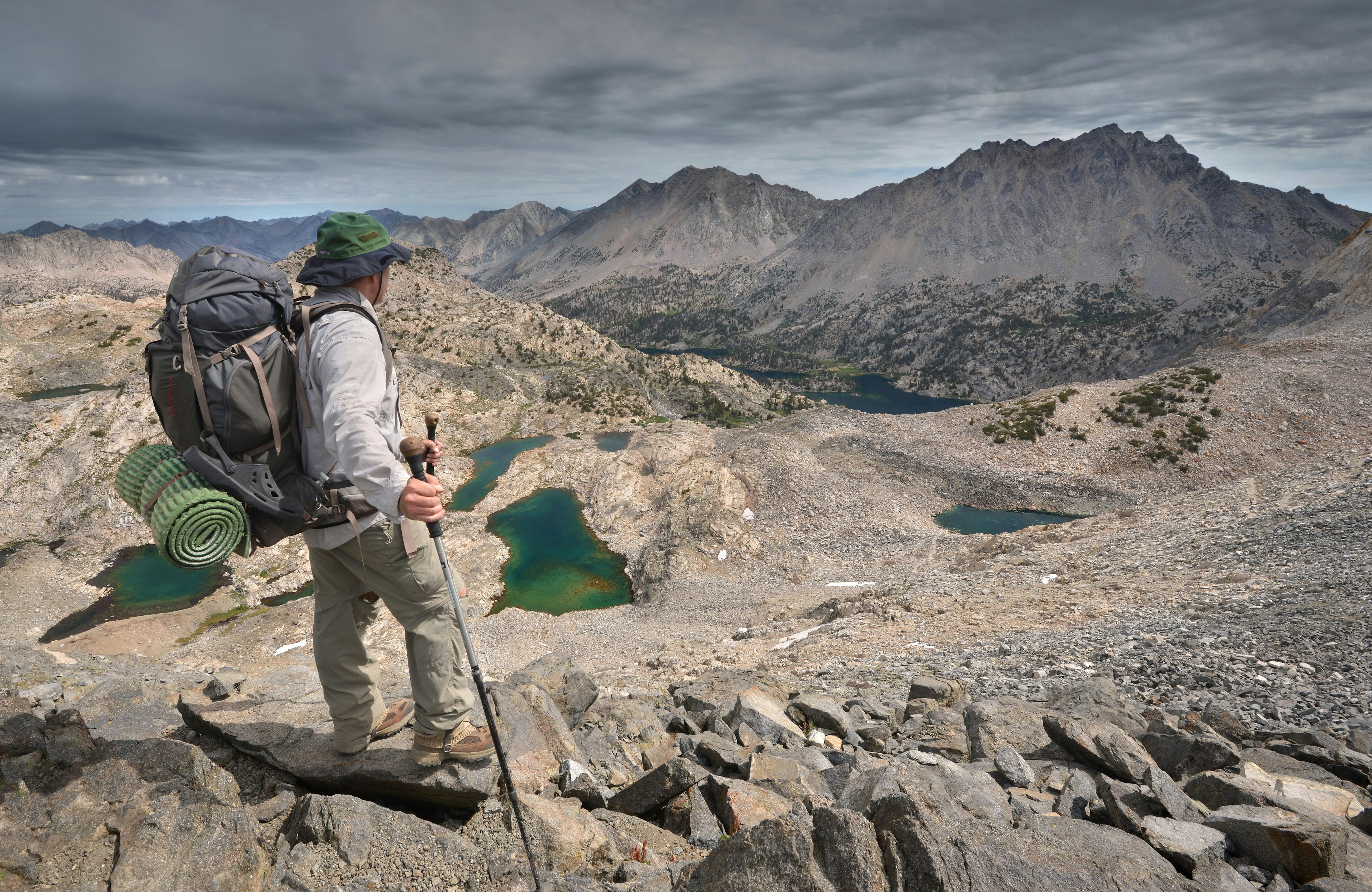 Male hiker standing on rocks atop Glen Pass, Kings Canyon National Park, California, USA