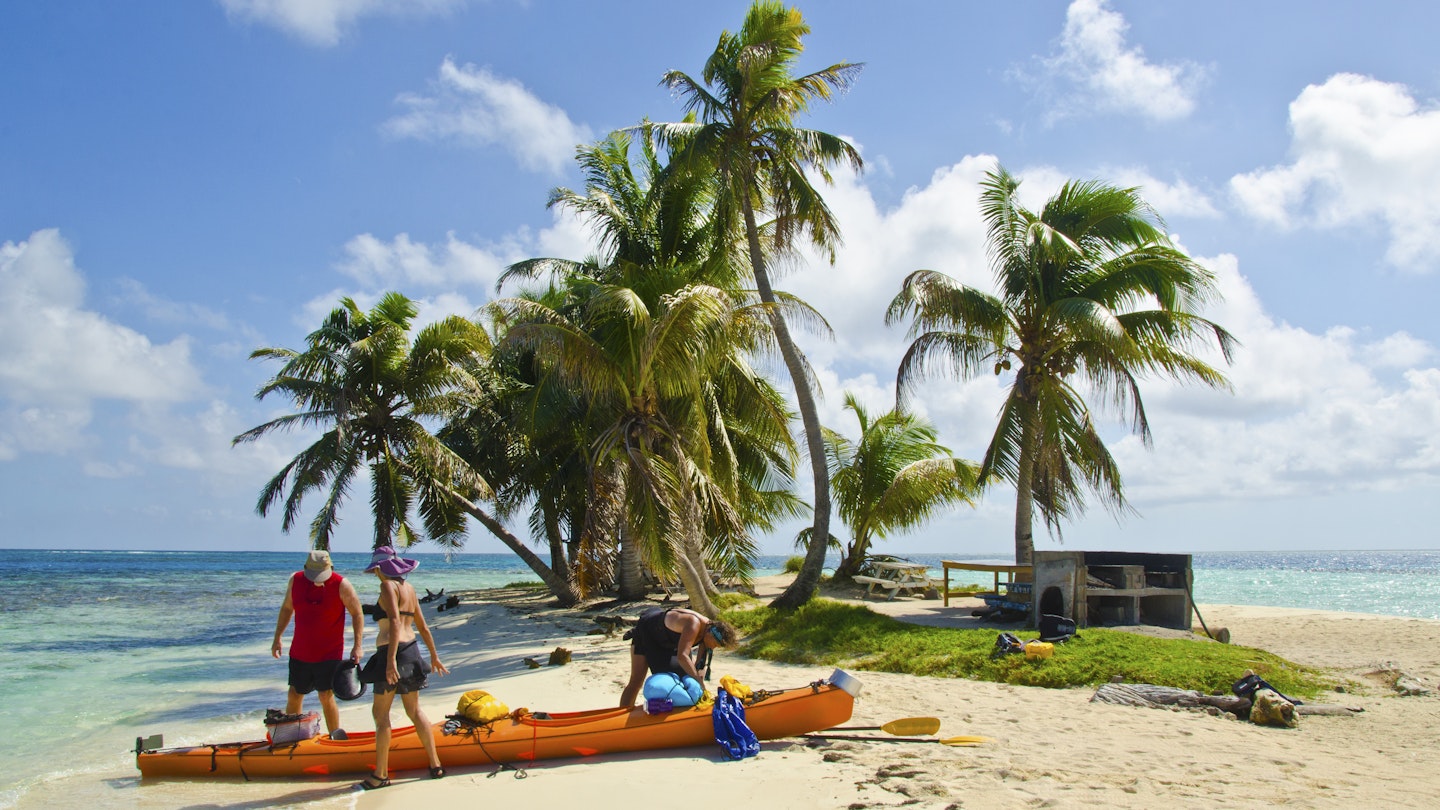 A couple gets instruction on efficient kayak packing. Barrier reef island, Belize, Caribbean Sea. Along the barrier reef off the coast of Belize there are many small islands like this one.
483629978
Eco Tourism, Travel, Three People, Group Of People, Beauty In Nature, Remote, Sea Kayaking, Kayak, Packing, Preparation, Advice, Getting Away From It All, Idyllic, Adventure, Tropical Climate, Vacations, Nature, Outdoors, Kayaking, Water Sport, Recreational Pursuit, People, Belize, Sand, Reef, Island, Beach, Caribbean Sea, Sea, Mode of Transport, Turquiose Water