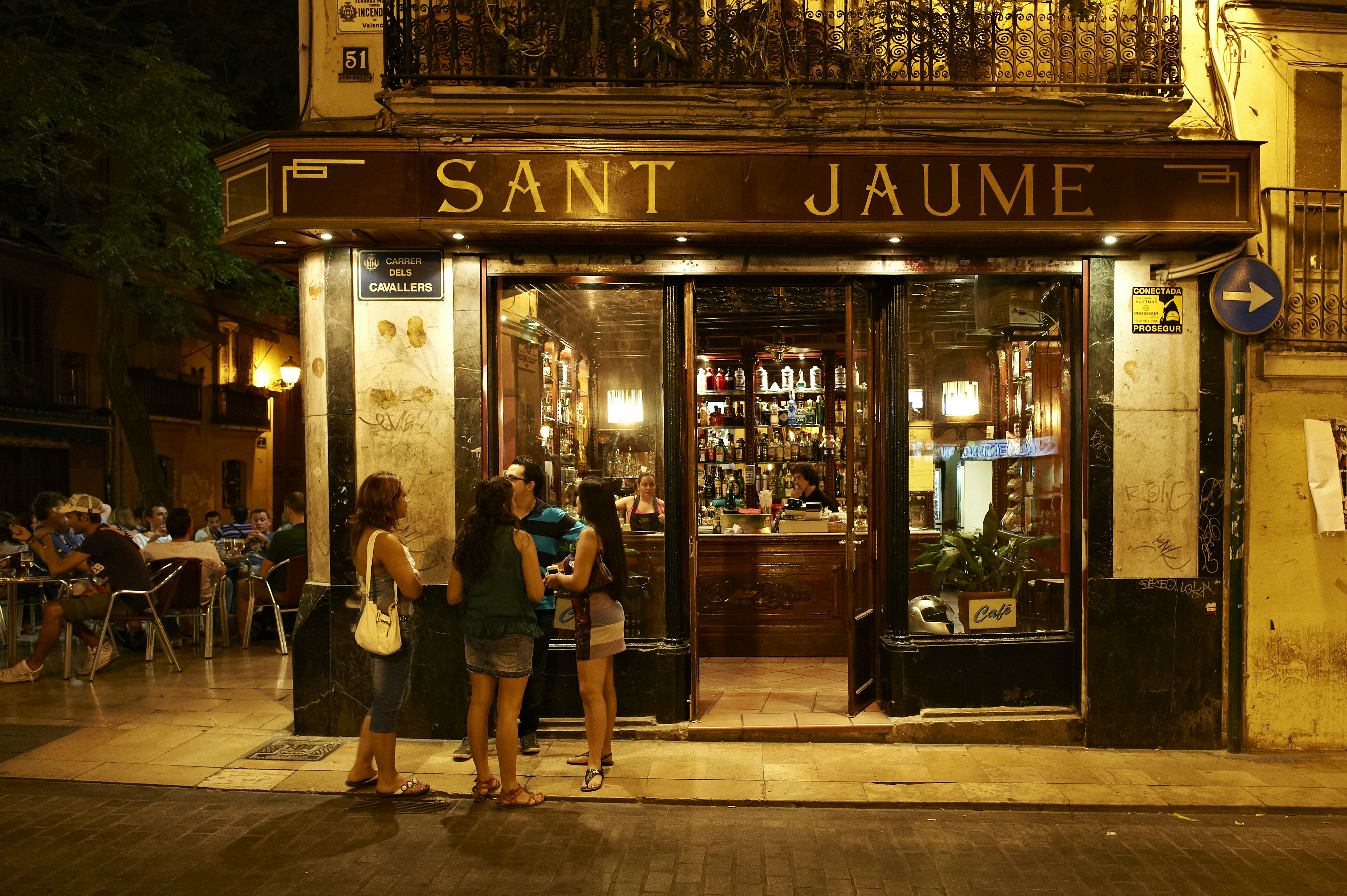 People socialize outside of a bar in Valencia, Spain.