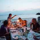 Family having meal on patio overlooking sea.
556439117
Water, Horizontal, Adult, Photography, Patio, Color Image, Italy, Illuminated, Togetherness, Girls, Illumination, Outdoors, Looking Away, Alcohol, Child, Place Setting, Real People, Lantern, Horizon, Food and Drink, Meal, Teenager, Sea, Leisure Activity, Men, 2015, Summer, Lamp, Drink, Sardinia, Eating, Horizon Over Water, Women, Europe, Candle, Furniture, Dusk, Family, Day, AutotagAuthentic - Do Not Delete, Food, Balcony, Multi-Generation Family, Bottle, Wine Bottle