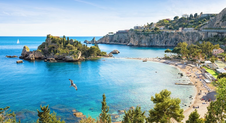 Isola Bella is small island near Taormina, Sicily, Italy. Narrow path connects island to mainland Taormina beach in azure waters of Ionian Sea. ; Shutterstock ID 1760426138; your: Brian Healy; gl: 65050; netsuite: Lonely Planet Online Editorial; full: 10 