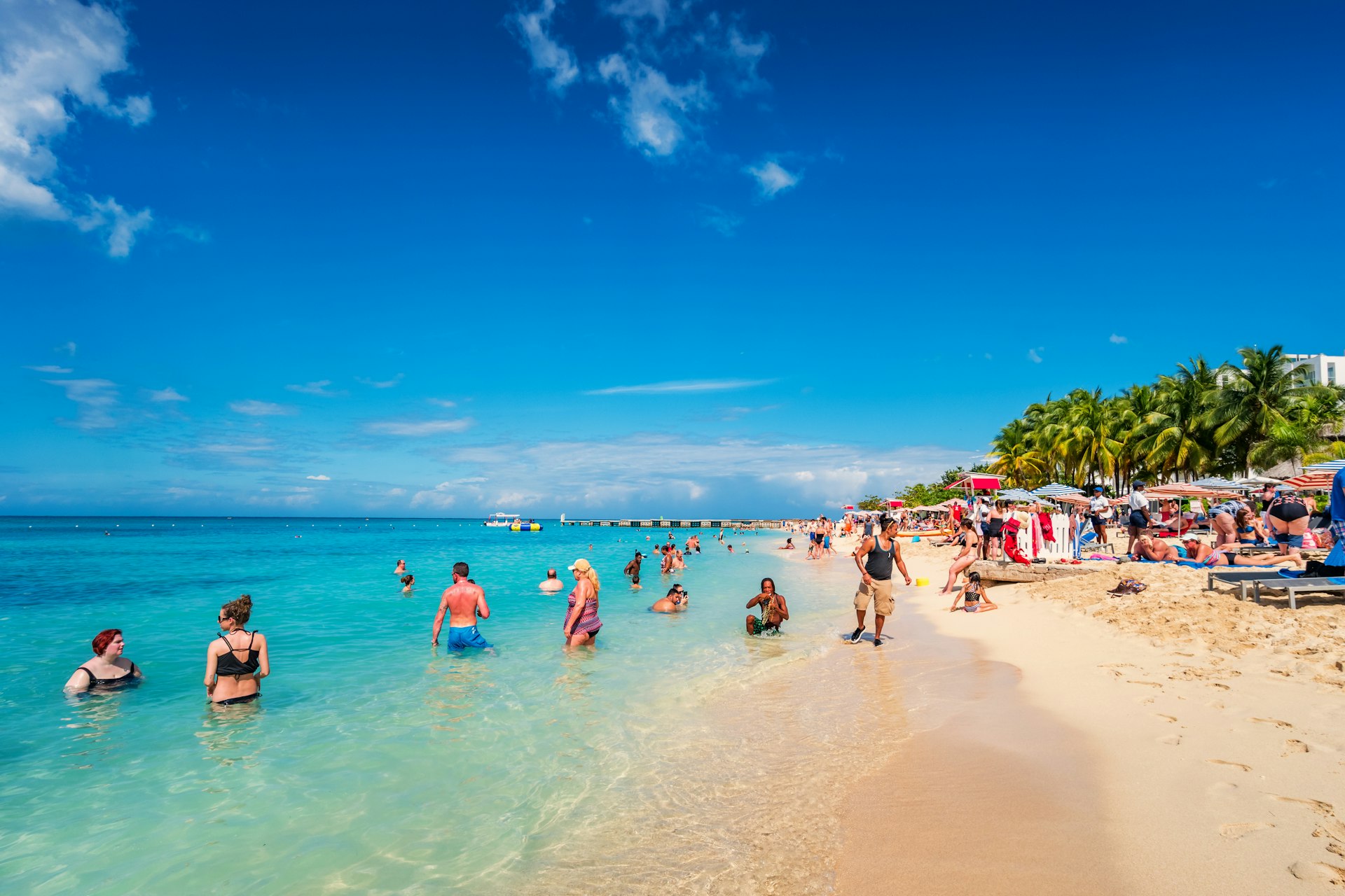 =Beachgoers relax at Doctor's Cave Beach in Montego Bay, Jamaica, on a sunny day