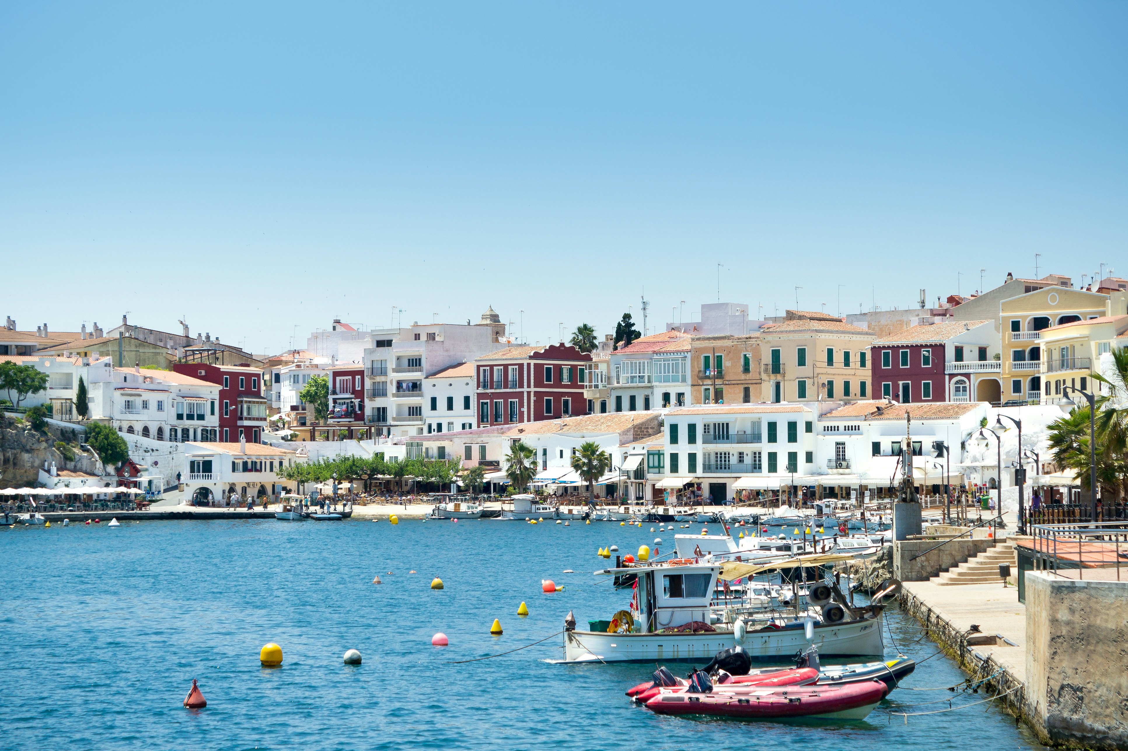 Moll des Cales Fonts harbour with boats moored on the right at the Balearic island Minorca, Menorca