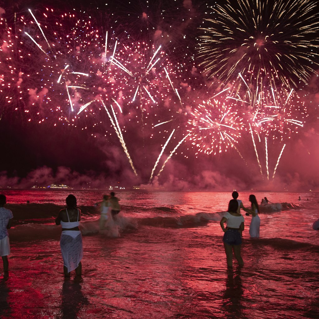 Revellers watch the fireworks on 1st January 2020 in Rio de Janeiro, Brazil. Every New Year's eve in Rio hundreds of thousands of people from all over the world descend on Copacabana and Ipanema beaches. It is the largest New Year's Eve celebration in the