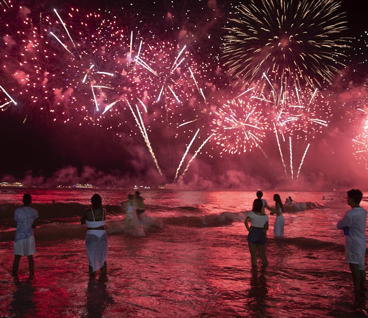 Revellers watch the fireworks on 1st January 2020 in Rio de Janeiro, Brazil. Every New Year's eve in Rio hundreds of thousands of people from all over the world descend on Copacabana and Ipanema beaches. It is the largest New Year's Eve celebration in the