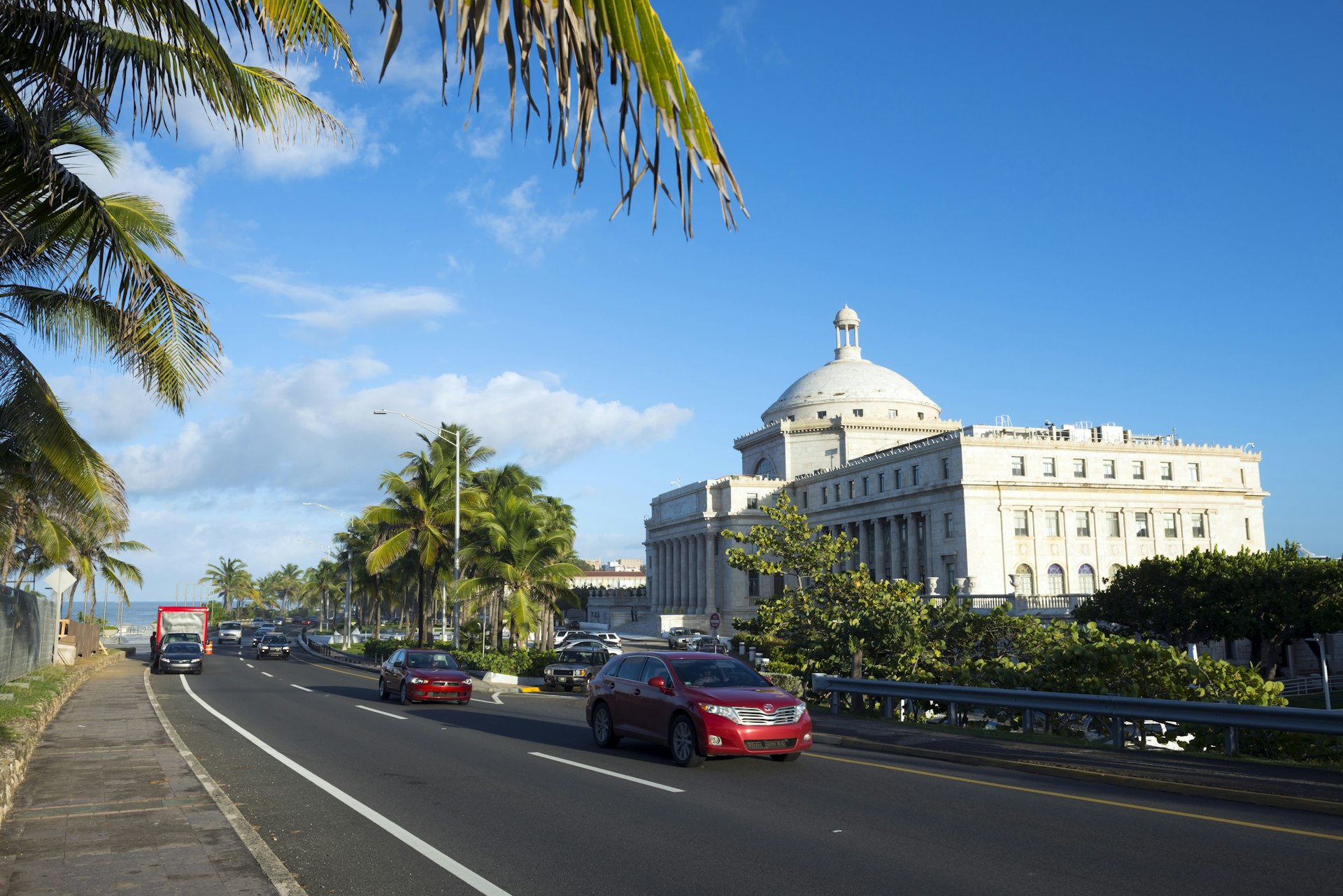 Cars travel past the Capitol Building (El Capitolio) in San Juan, Puerto Rico.