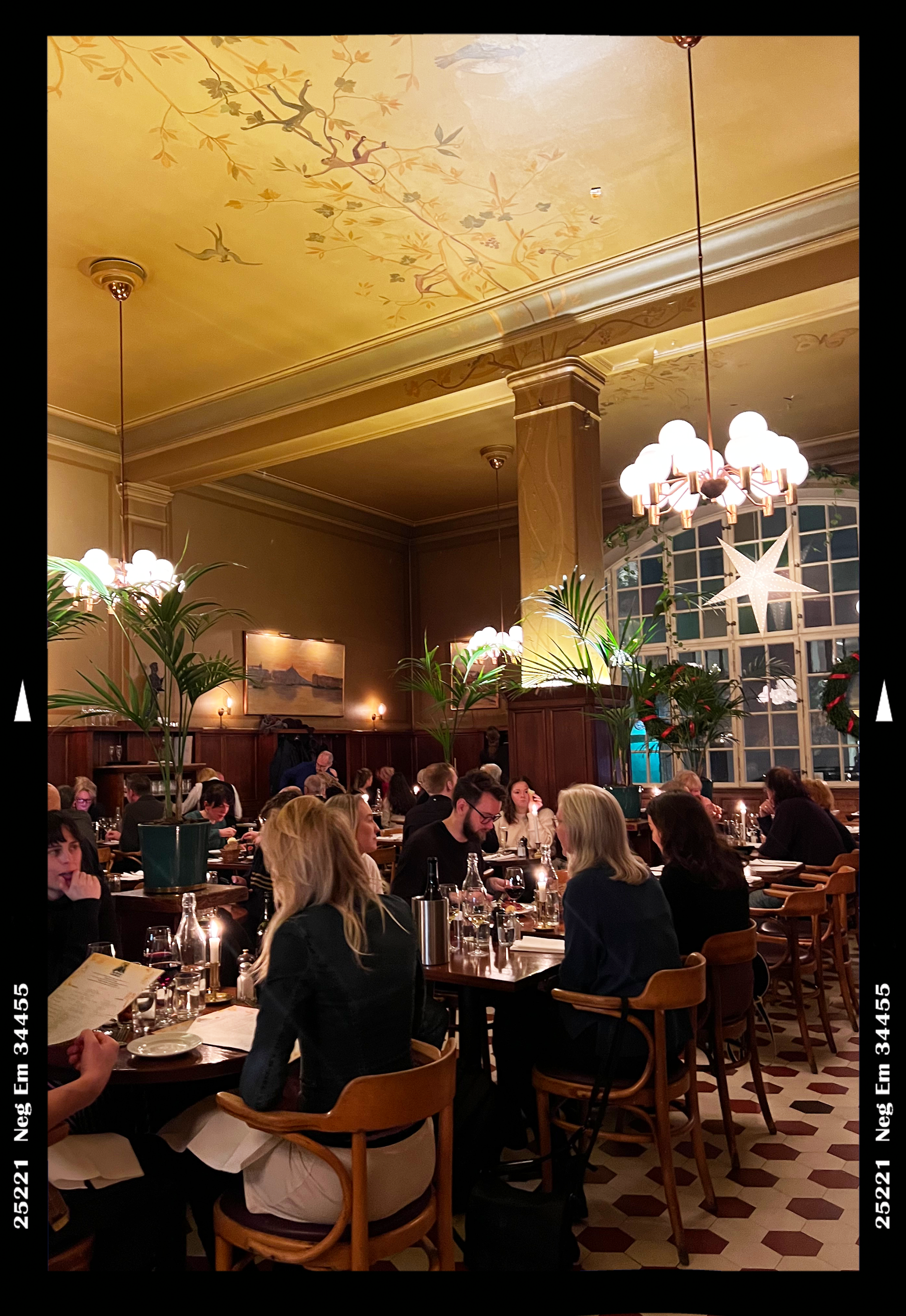 A dinner scene in a dimly-lit and elegant restaurant in Stockholm 