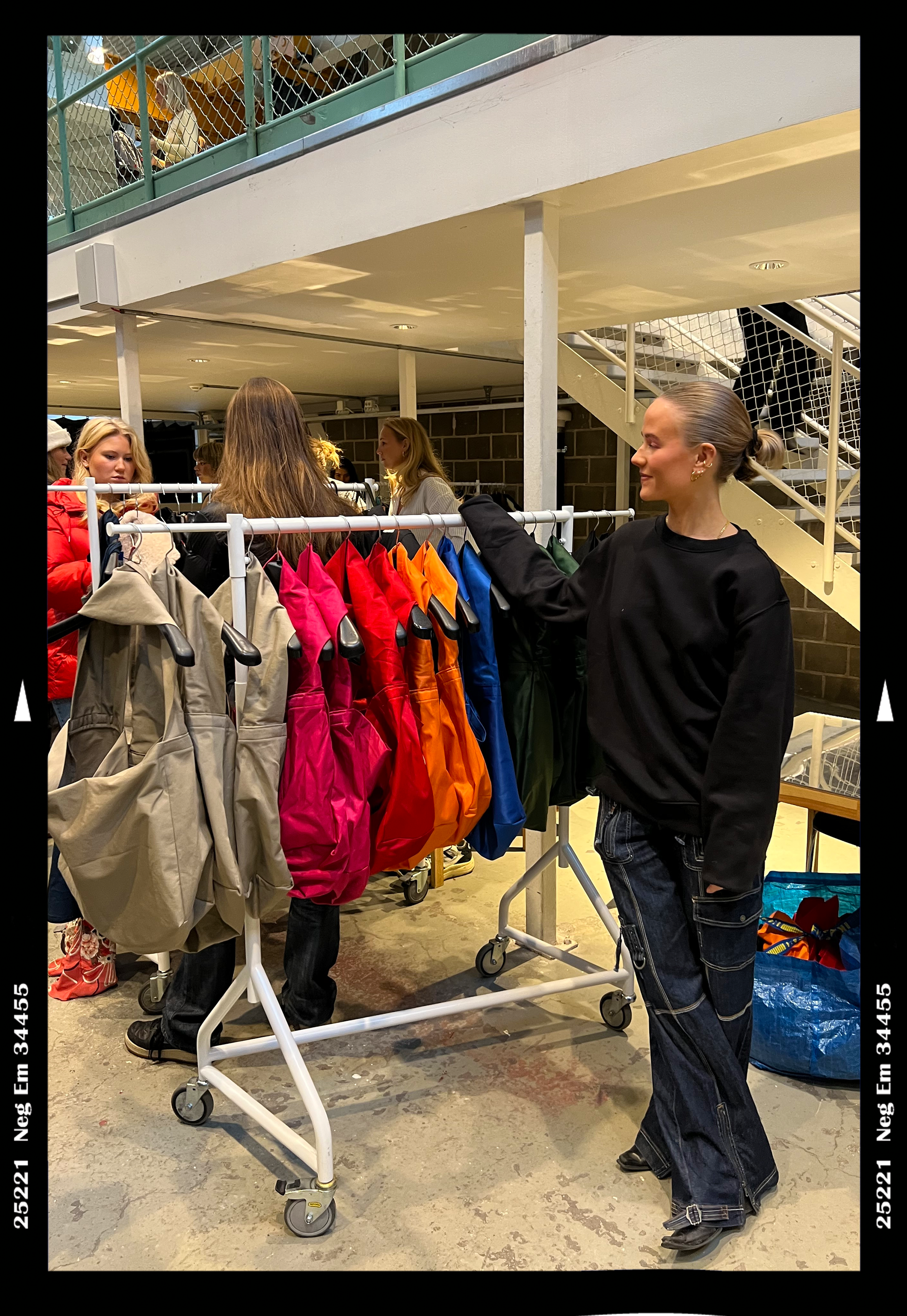 A rail of colorful bags in a Stockholm shop