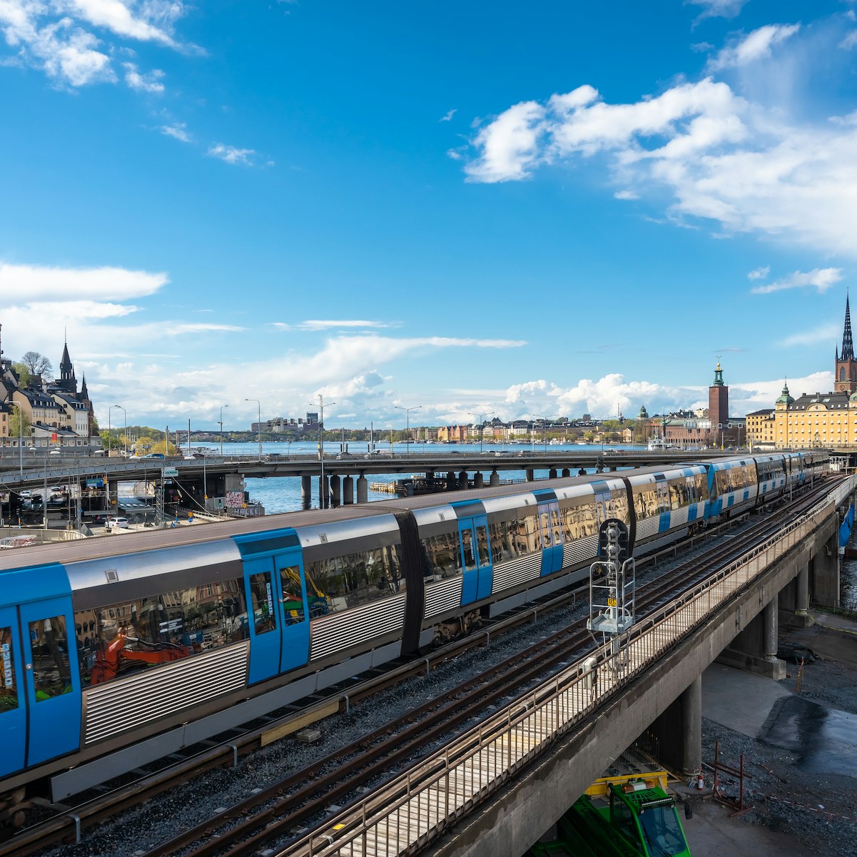 Panoramic view of the center of Stockholm. The metro train moving the Slussen district. Amazing view of the Sodermalm  island, The City Hall,  Riddarholmen in Gamla Stan. Text on road signs "Old Town"; Shutterstock ID 1722718684; your: Brian Healy; gl: 65