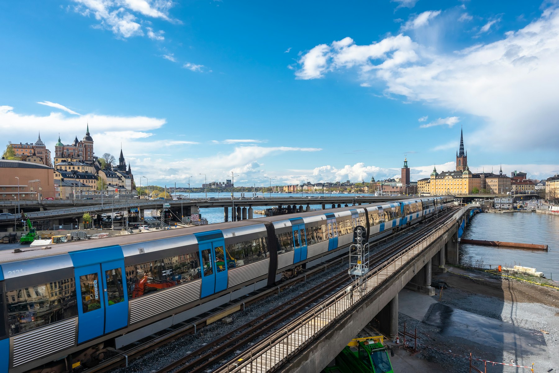 Panoramic view of the center of Stockholm. The metro train moving the Slussen district. Amazing view of the Sodermalm  island, The City Hall,  Riddarholmen in Gamla Stan. Text on road signs "Old Town"; Shutterstock ID 1722718684; your: Brian Healy; gl: 65