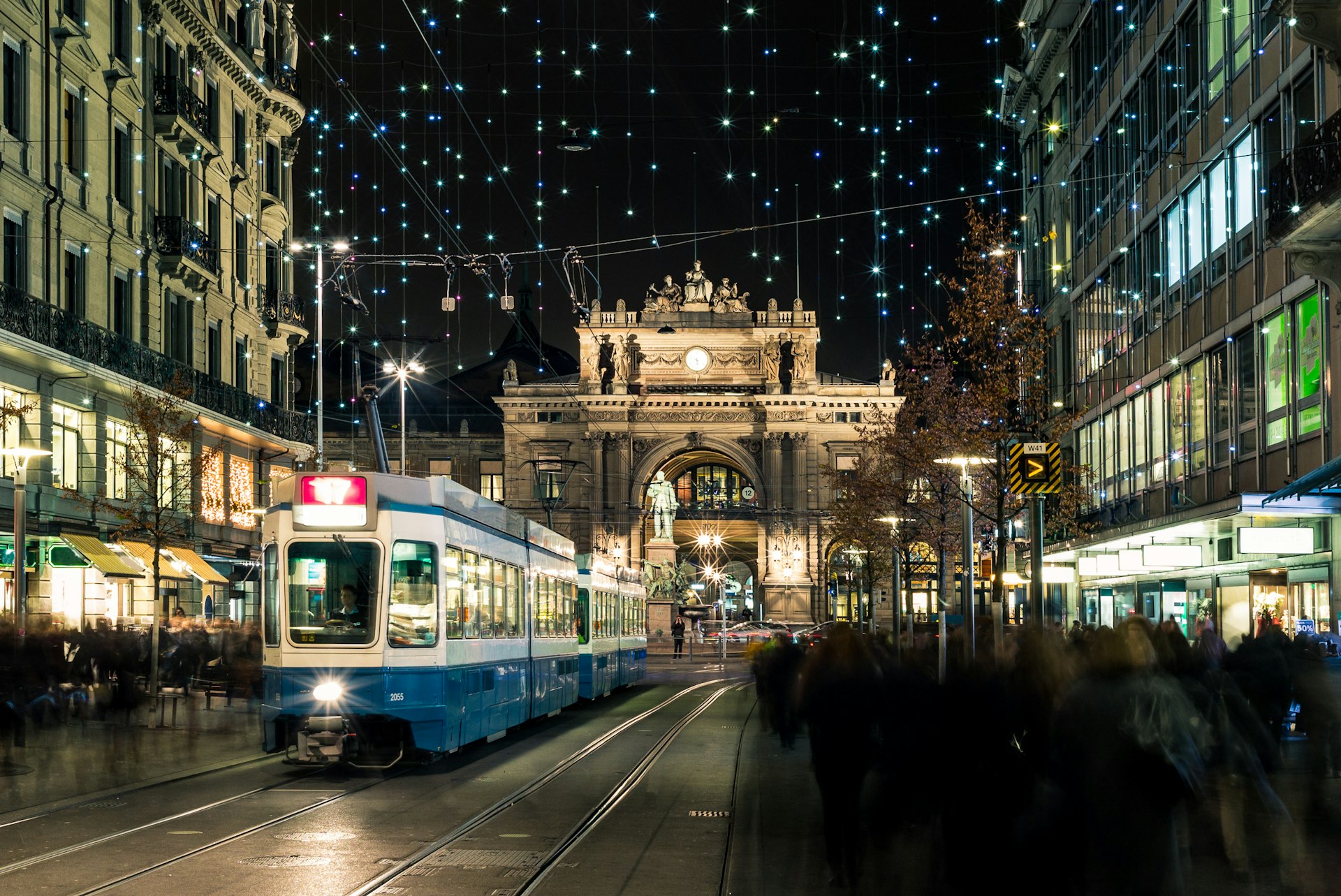Christmas shopping in the decorated Zurich Bahnhofstrasse with a tram in the foreground
