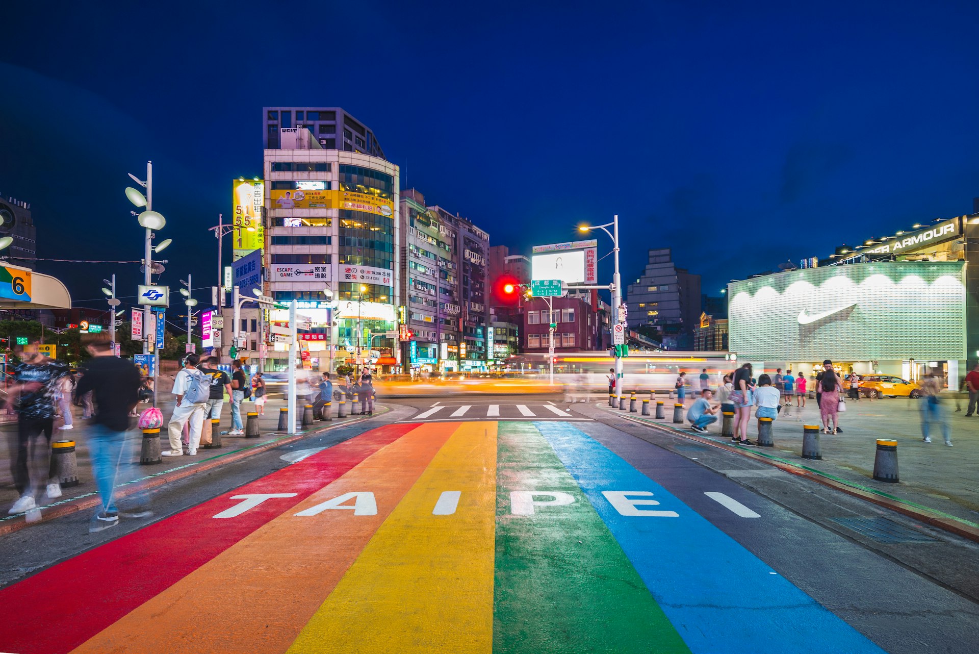 A rainbow walkway painted on the street spelling out TAIPEI
