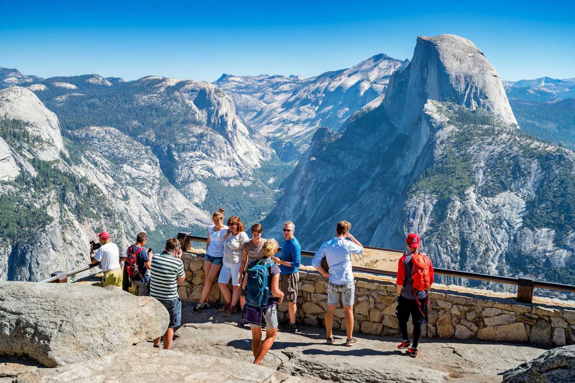 Visitors enjoy the view from Glacier Point lookout in Yosemite National Park, California