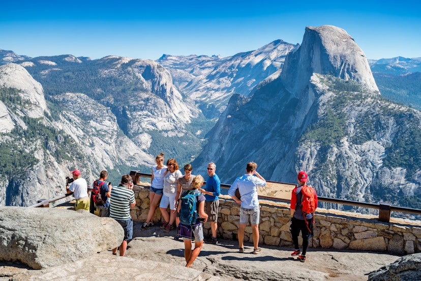 Visitors enjoy the view from Glacier Point lookout in Yosemite National Park, California, USA on a sunny day.
1133650354
california, national park, yosemite national park, yosemite valley, blue, glacier point, nature, outdoors, people, sky, sunny, viewpoint, visit, tourist, tourism, rock - object, mountain, mountain range, landscape - scenery, famous place, travel destinations, scenics - nature, travel, beauty in nature, group of people, valley, clear sky, large group of people, western usa, half dome, californian sierra nevada