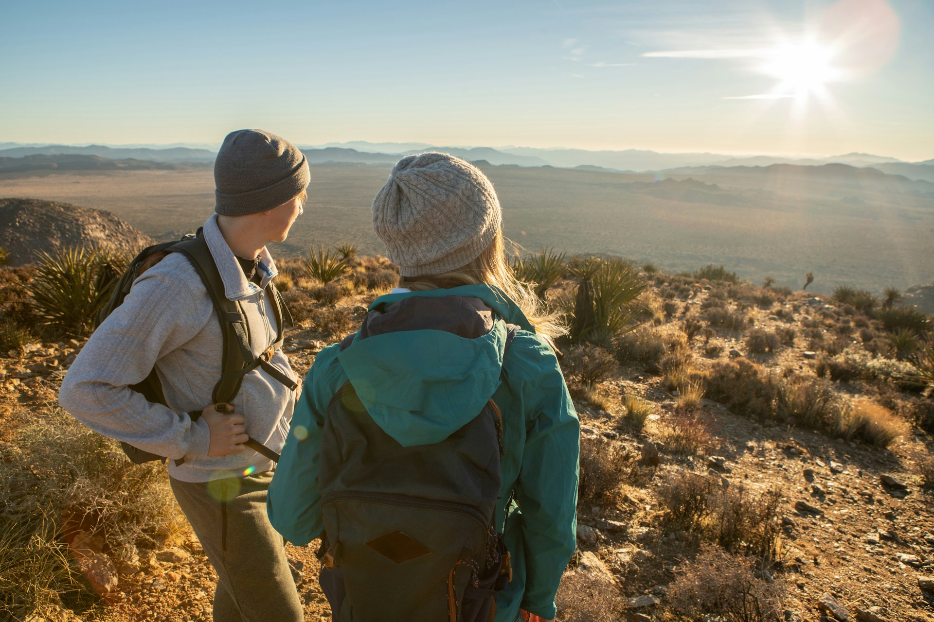 Hikers looking out over California mountains and valleys