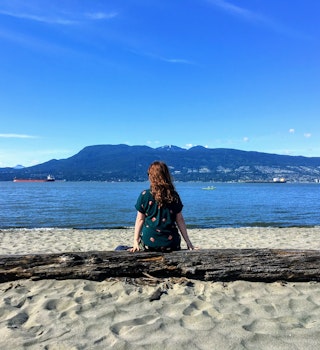 A from behind view of a beautiful young woman sitting on a log on the beach on a beautiful sunny day, deep in thought staring out at the ocean and mountains in Vancouver, British Columbia, Canada.
1151069150
admiring, background, bay, beautiful, blue sky, coast, contemplating, deep in thought, female, from behind, girl, landscape, mountains, ocean, outdoor, person, perspective, pretty, thinking, vancouver, view, woman, young