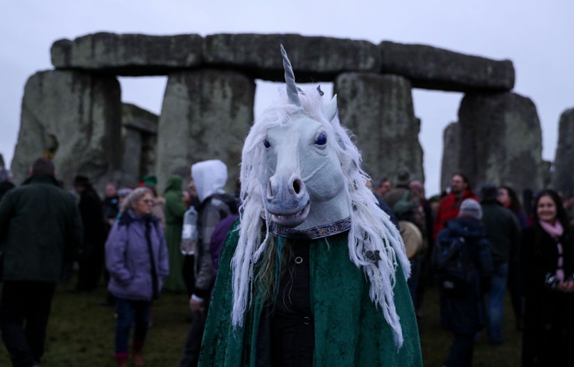 People gather at Stonehenge in Wiltshire on the winter solstice to witness the sunrise after the longest night of the year. (Photo by Andrew Matthews/PA Images via Getty Images)