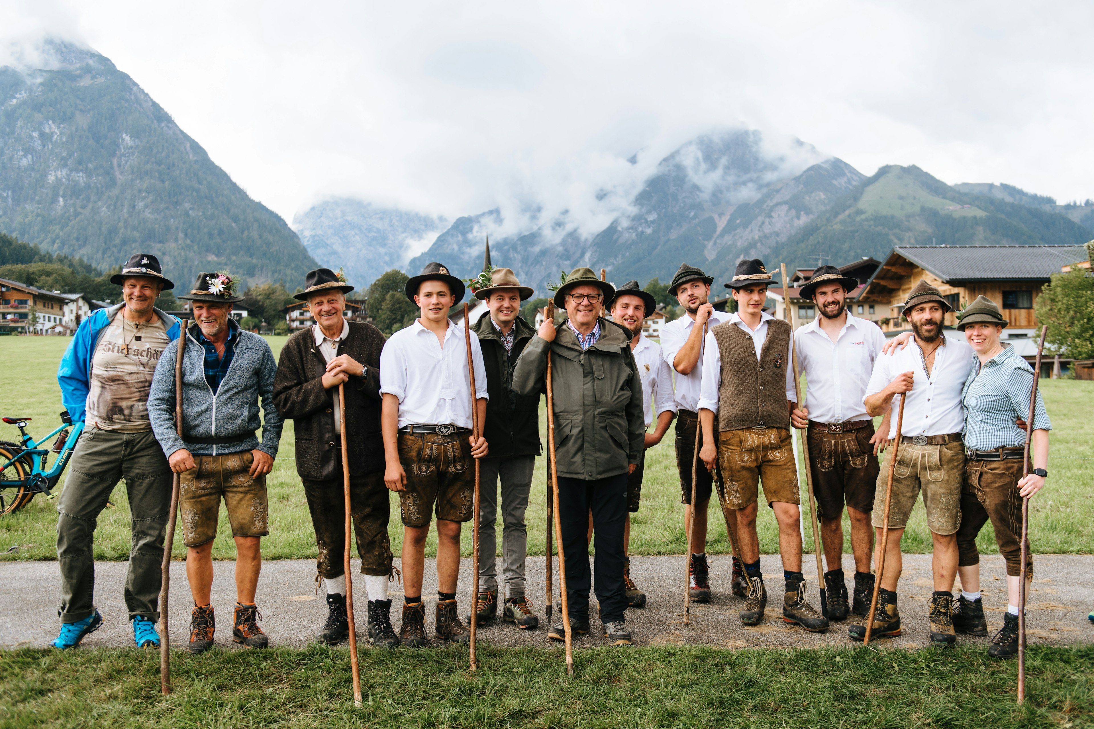 A group of herders stop for a group portrait after dressing their cows