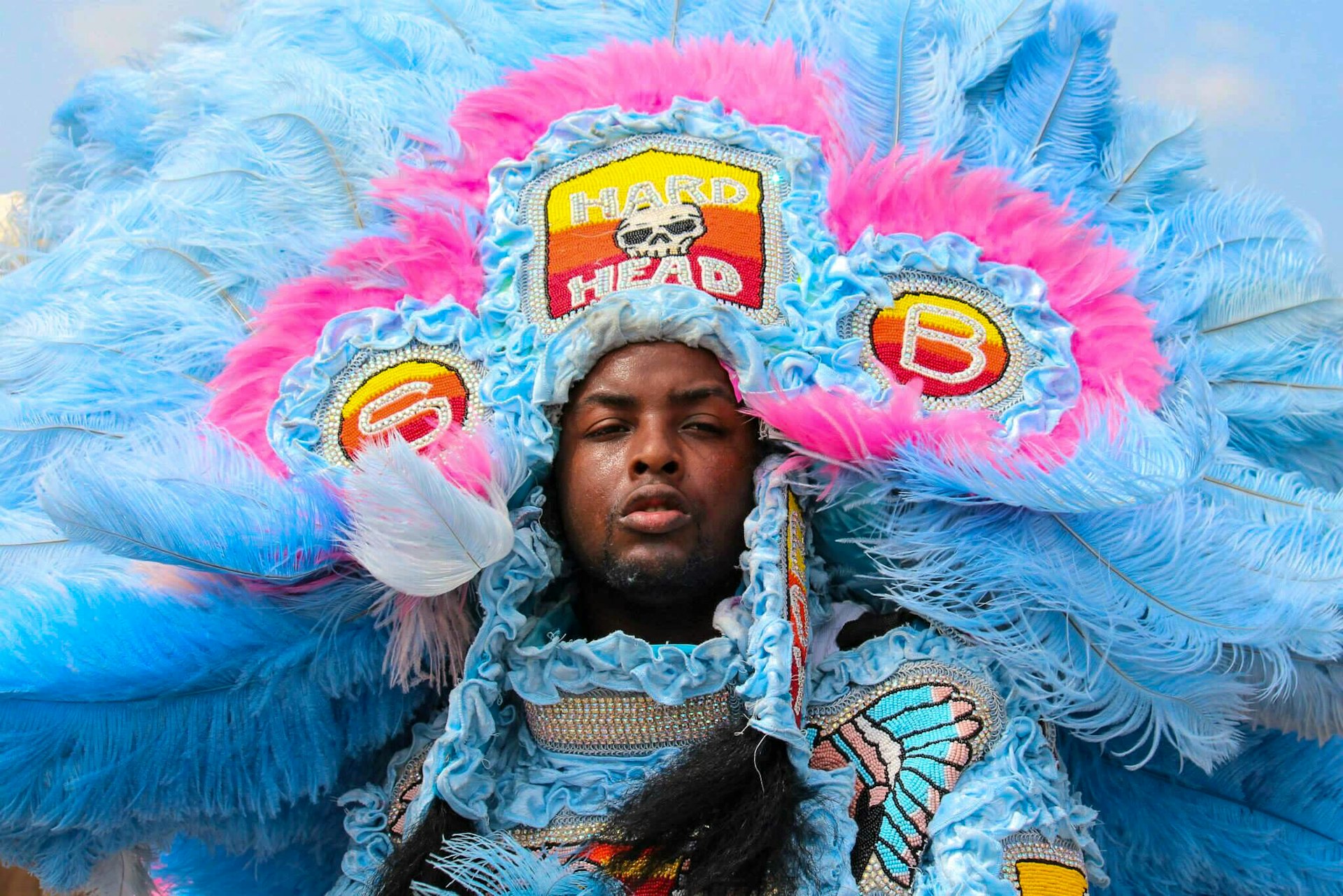 A Mardi Gras Indian dressed in an elaborate blue feathered costume in New Orleans
