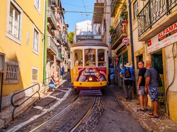 August 22, 2017: People stepping to the sidewalk in order to let the street car pass in the streets of Lisbon.
755689225
urban, tourist attraction, city center, pedestrian street, street tramway, front view, classic, horizontal, lisboa, old, old fashioned, people, portugal, portuguese, rail, rail transport vehicle, summer, tourism, transport, travel, yellow, alfama, busy, cable car, campo ourique, capital, center, city, cobblestone street, day, electric, famous, journey, known, line, martin moniz, moving aside, moving away, pavement, prazeres, sidewalk, sightseeing, stepping away, street, streetcar, sunny, tourists, tram, trolley car, unique