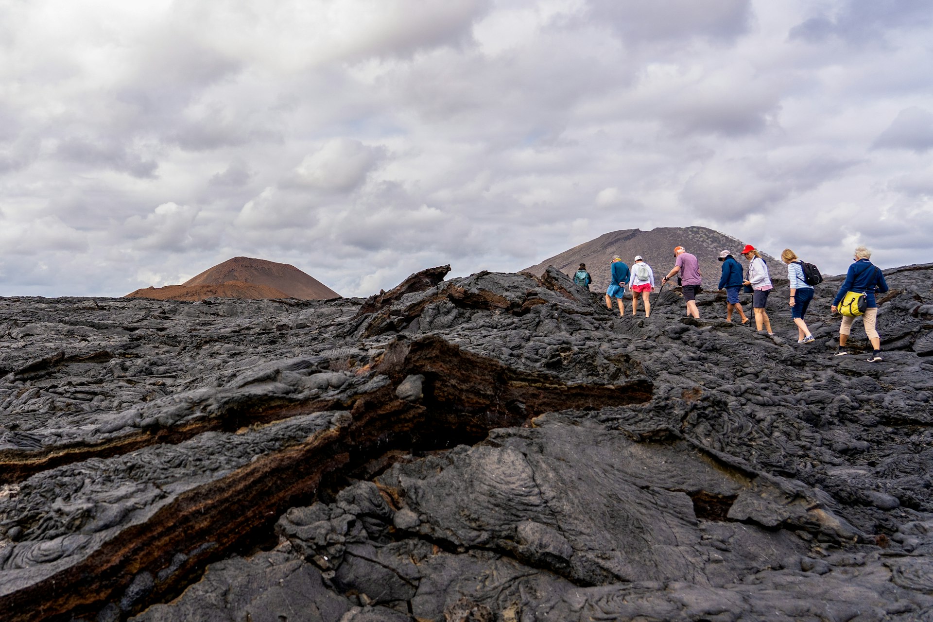 Group of people hiking up a rocky island in the Galapagos