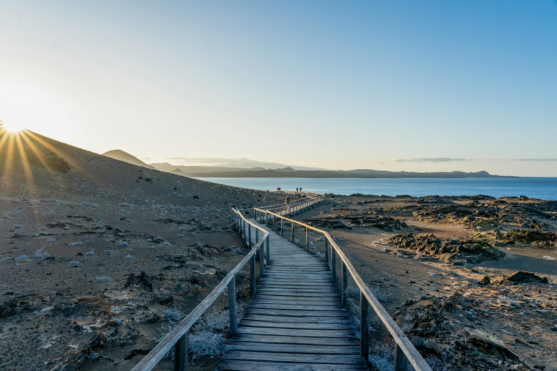 A wooden trail leading to the beach over a rocky island