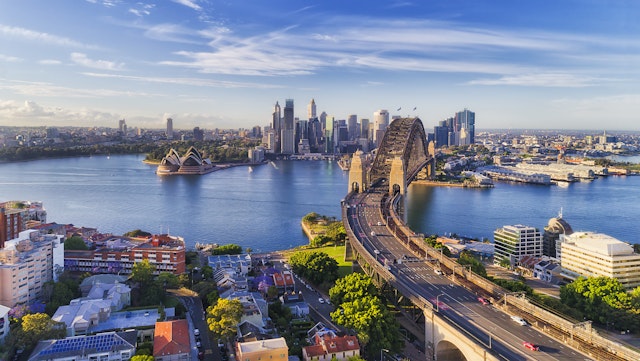 Cahill express way to the Sydney Harbour bridge across Sydney harbour towards city CBD landmarks in aerial eleveated wide view under blue morning sky tasmin waby