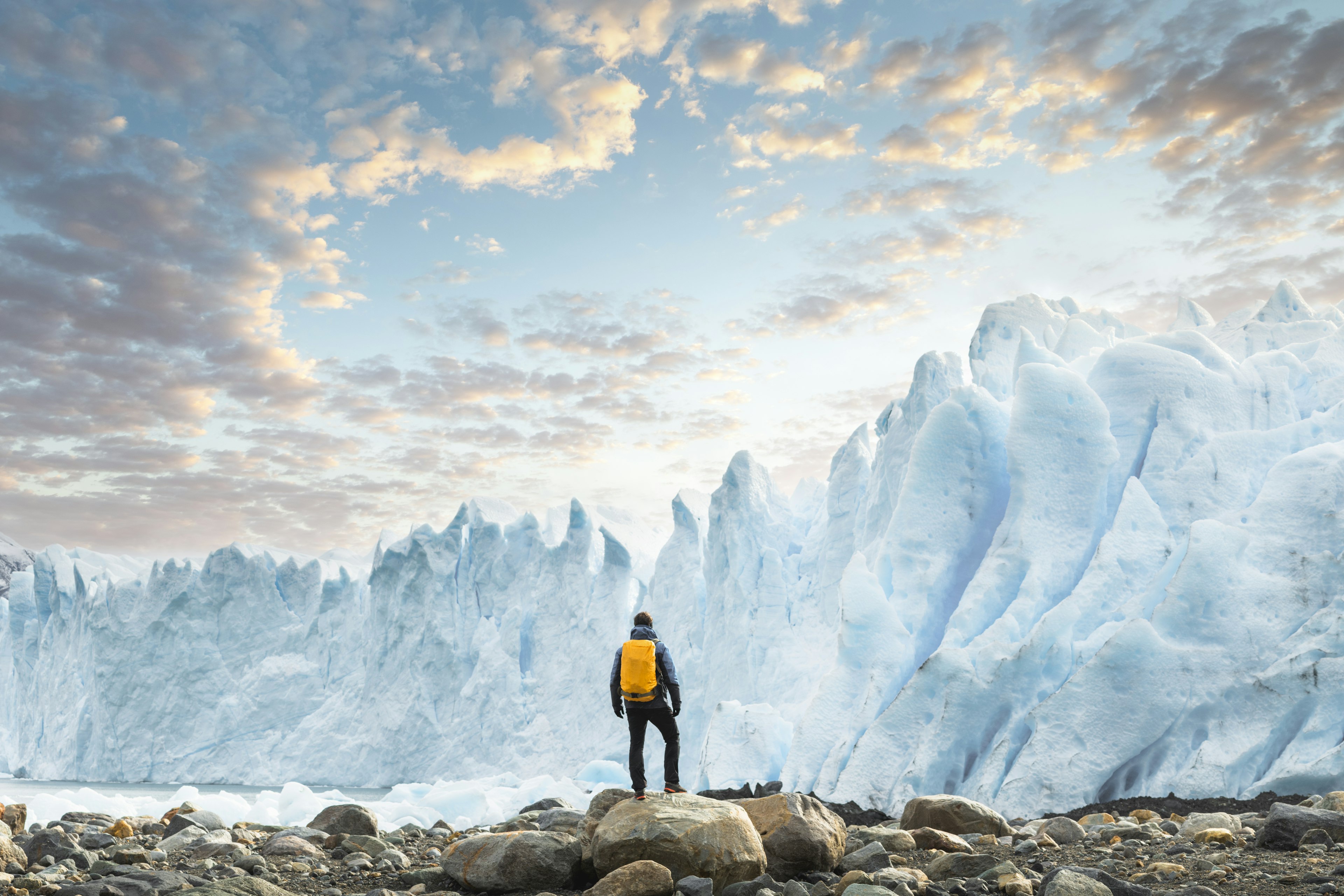 Hiker admiring the Perito Moreno glacier at sunset, Argentina