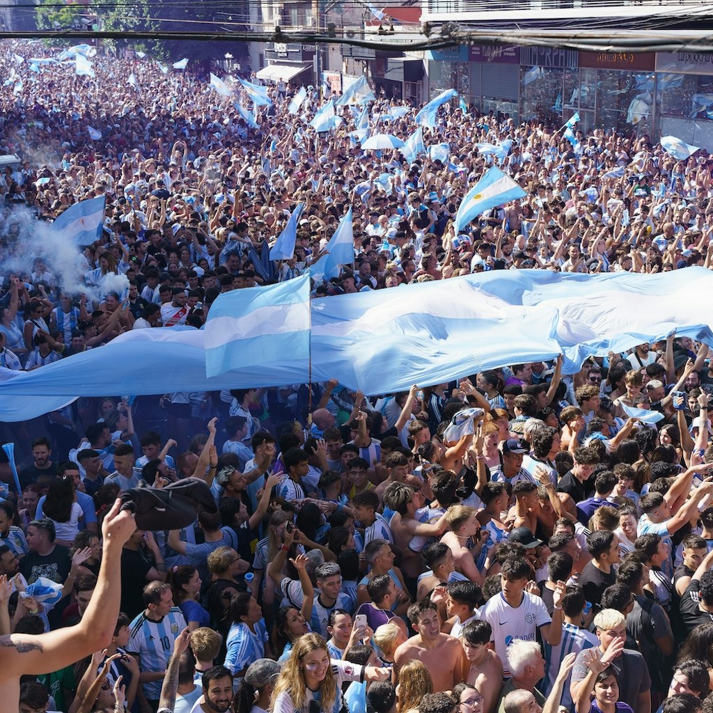 Buenos Aires, Argentina - December 18, 2022: Happy Argentine football fans celebrate winning a final football match at the Qatar 2022 FIFA World Cup.; Shutterstock ID 2240007849; your: Brian Healy; gl: 65050; netsuite: Lonely Planet Online Editorial; full: Best time to visit Buenos Aires
2240007849
2022, argentina, argentine, argentinian, buenos aires, celebrating, celebration, champion, championship, cheerful, cheering, city, crowd, culture, cup, event, face, fan, fans, fashion, festival, fifa, fifa world cup, final, flag, football, fun, game, group, happy, holidays, man, match, messi, national, person, player, qatar, soccer, sport, stadium, street, team, travel, uniform, victory, win, woman, world