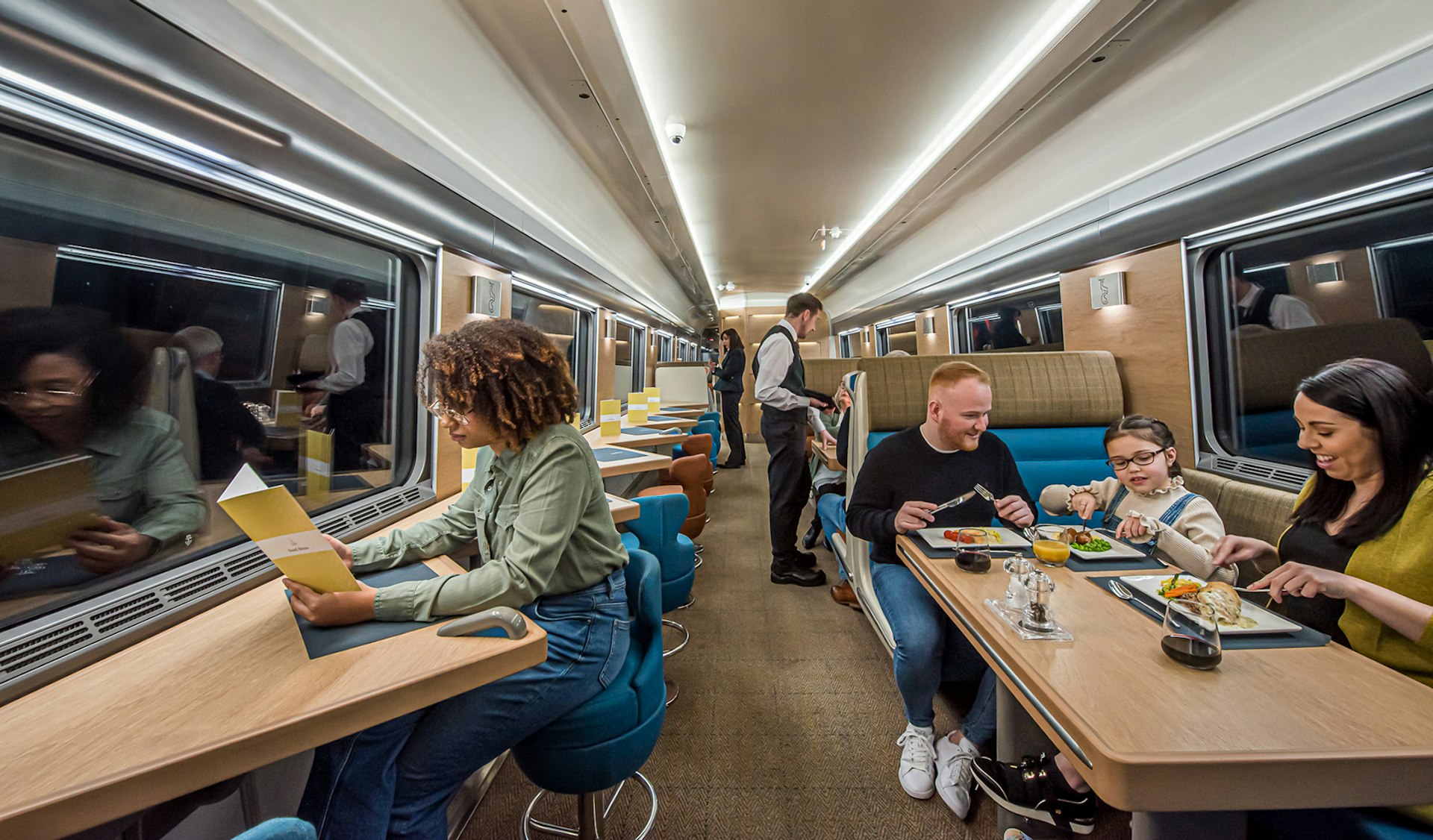 Passengers eat at tables in the Club Car aboard the Caledonian Sleeper overnight train between London and Scotland