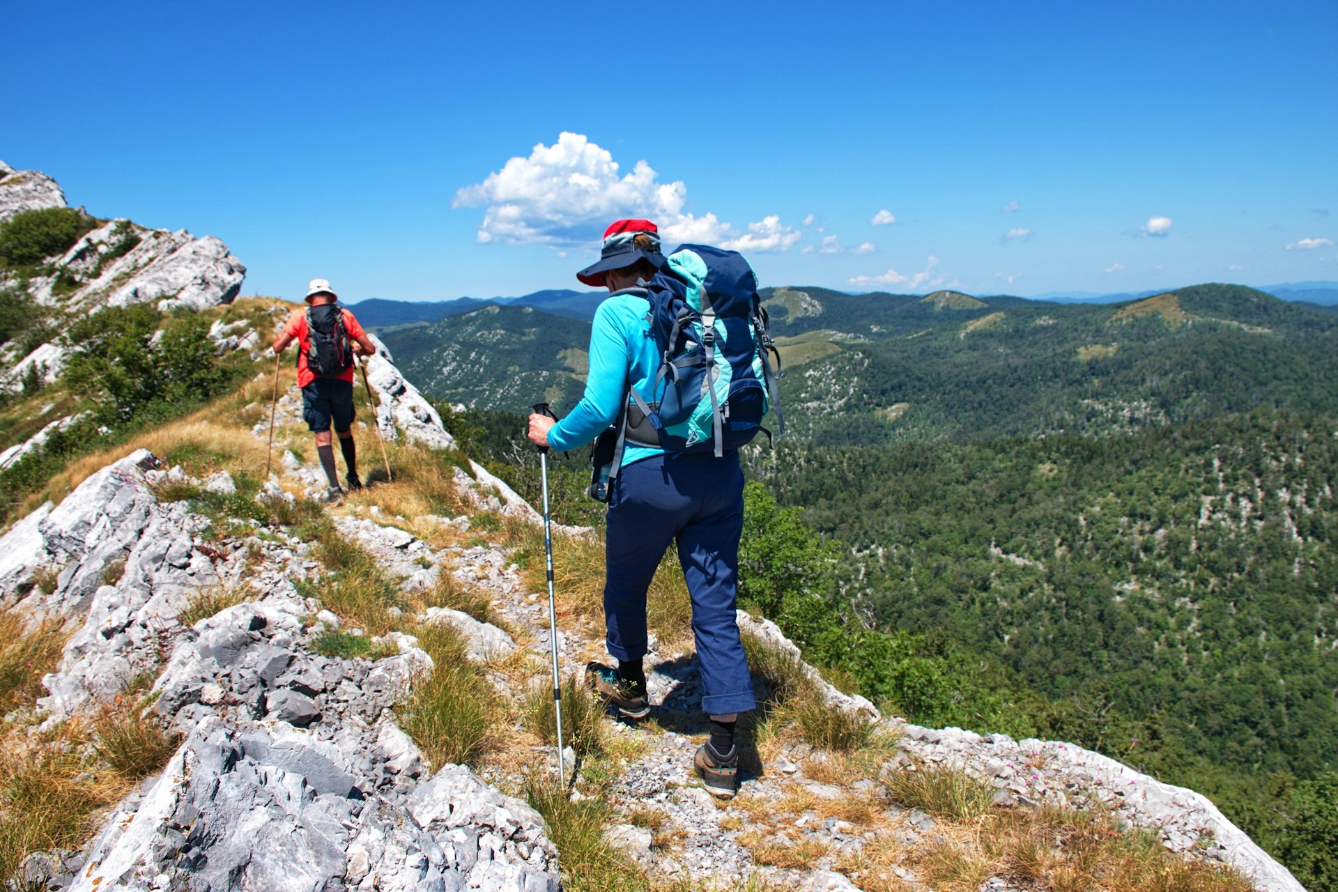 Two people hike along a mountain in Croatia. 