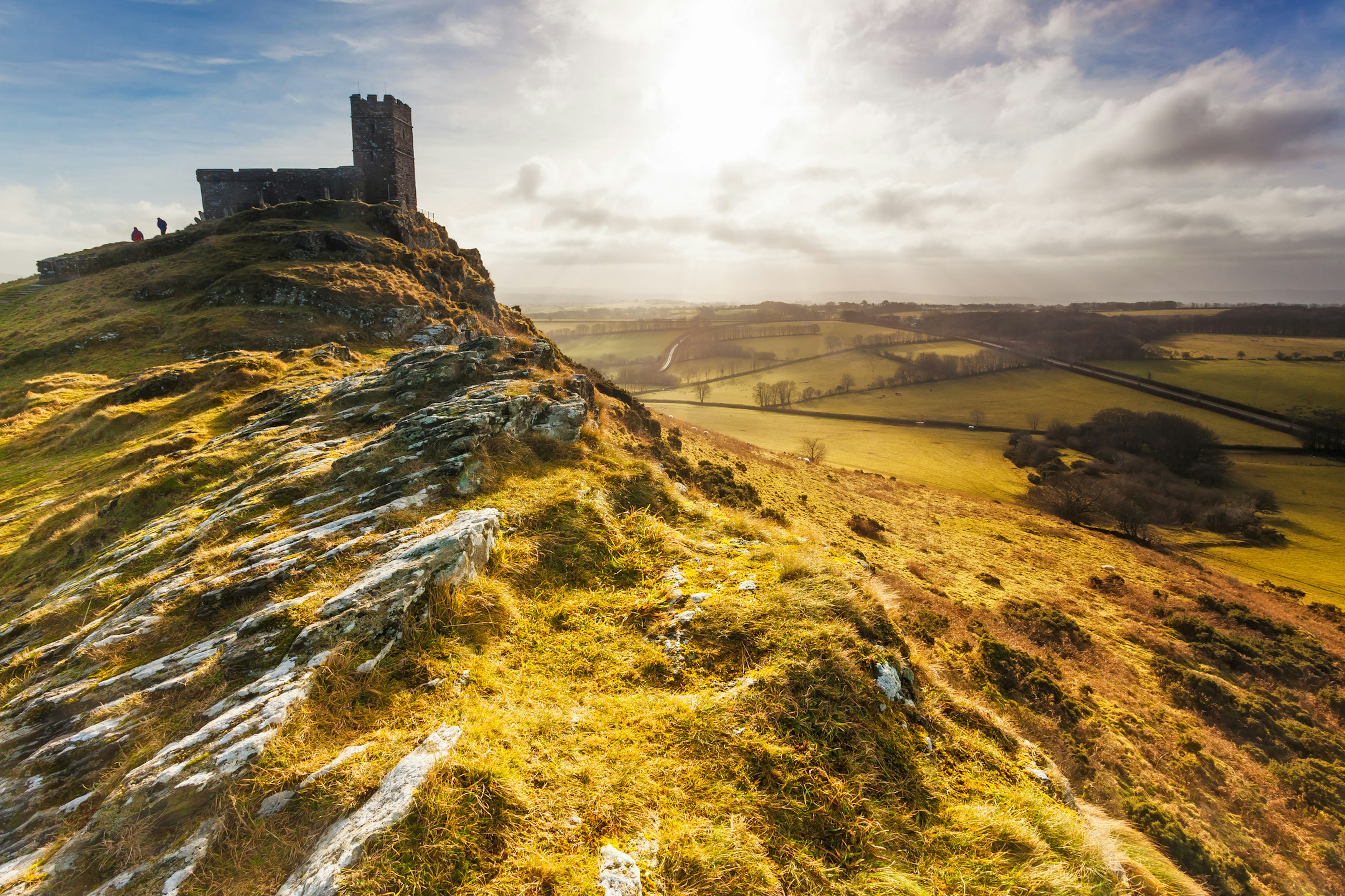 A church sits high up on a hill in the English countryside.