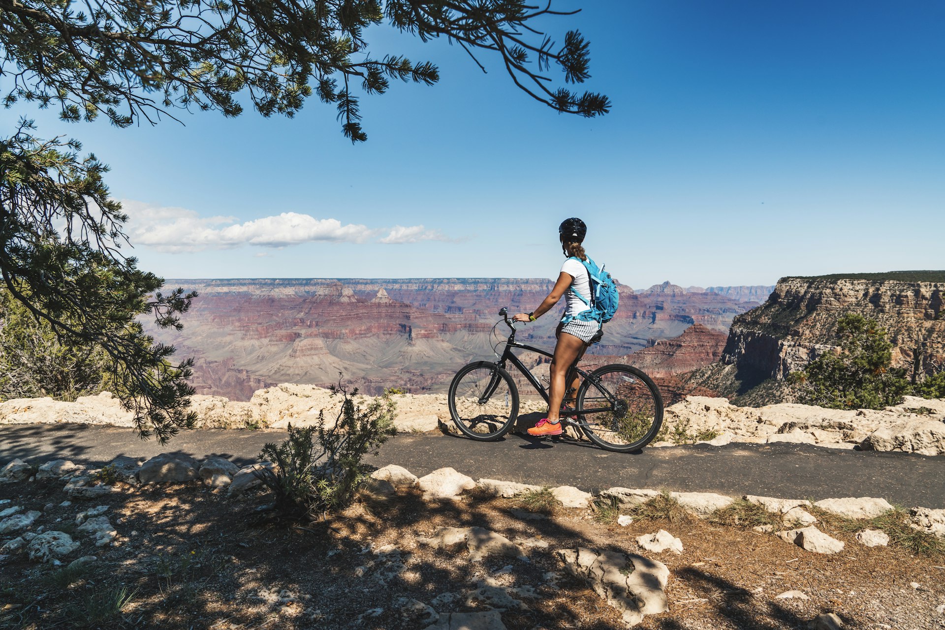 Young woman cycling through Grand Canyon park 