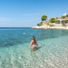 Woman wearing a bikini bathing in the Adriatic sea in summer. Murvica, Bol, Brac island, Split - Dalmatia county, Croatia.
1128294852
Woman wearing a bikini bathing in the Adriatic sea in summer. Murvica, Bol, Brac island, Split