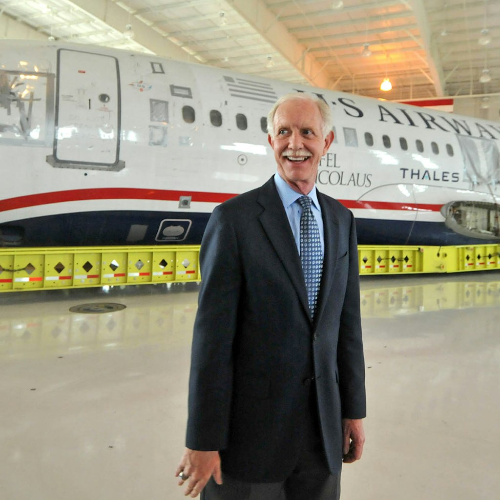 Capt. Chesley Sullenberger, stands in front of the US Airways flight 1549 fuselage at the Carolinas Aviation Museum where he and other crew members met with passengers to recall their memorable water landing in the Hudson River and to celebrate the plane's arrival at the museum.