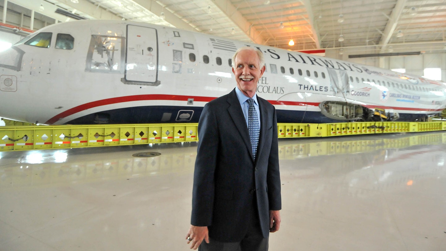 Capt. Chesley Sullenberger, stands in front of the US Airways flight 1549 fuselage at the Carolinas Aviation Museum where he and other crew members met with passengers to recall their memorable water landing in the Hudson River and to celebrate the plane's arrival at the museum.