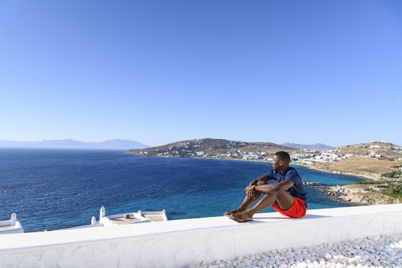 The African man sits on a white wall and admires the view.
1167004783