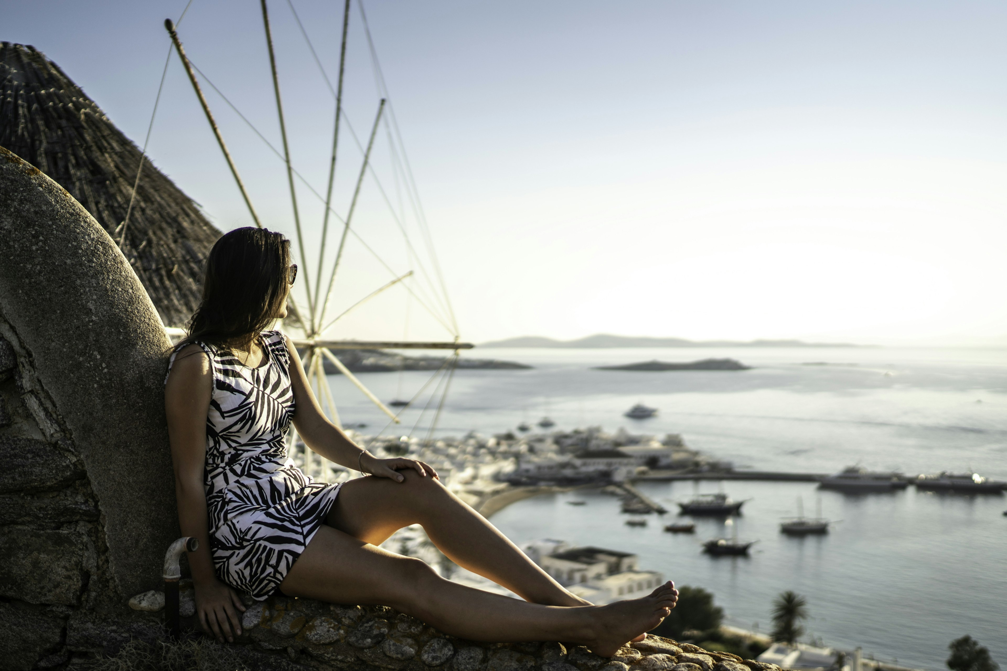 Young Woman Sitting And Enjoying The View Of The Sea