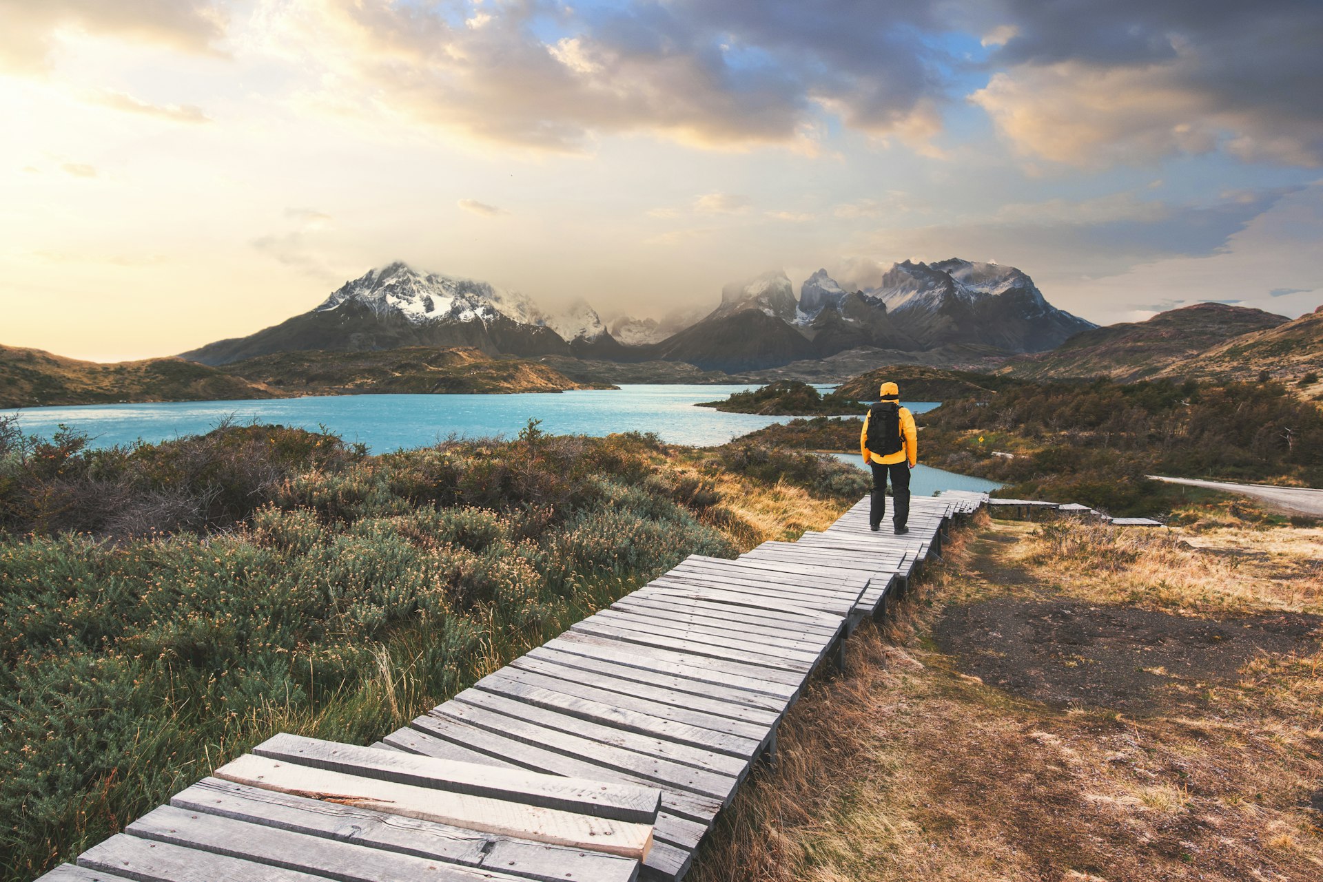 A hiker on a wooden walkway in Torres del Paine National Park, Patagonia, Chile