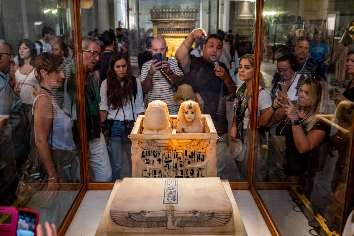 A guide briefs tourists before canopic jars which contained the organs of the ancient Egyptian New Kingdom Pharaoh Tutankhamun (1332-1323 BC) at his tomb KV62, displayed with the Tutankhamun collection at the Egyptian Museum in the centre of Egypt's capital Cairo on November 6, 2022. - The resting place of Egypt's pharaoh Tutankhamun has become the world's most famous tomb, its discovery 100 years ago among the greatest archaeological discoveries of all time.