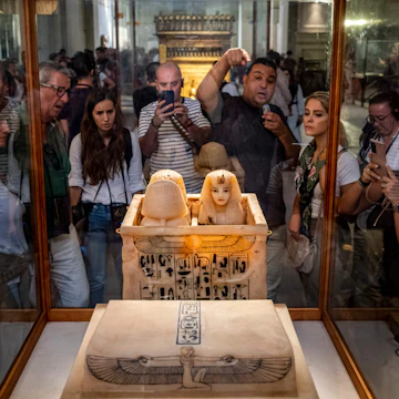 A guide briefs tourists before canopic jars which contained the organs of the ancient Egyptian New Kingdom Pharaoh Tutankhamun (1332-1323 BC) at his tomb KV62, displayed with the Tutankhamun collection at the Egyptian Museum in the centre of Egypt's capital Cairo on November 6, 2022. - The resting place of Egypt's pharaoh Tutankhamun has become the world's most famous tomb, its discovery 100 years ago among the greatest archaeological discoveries of all time.