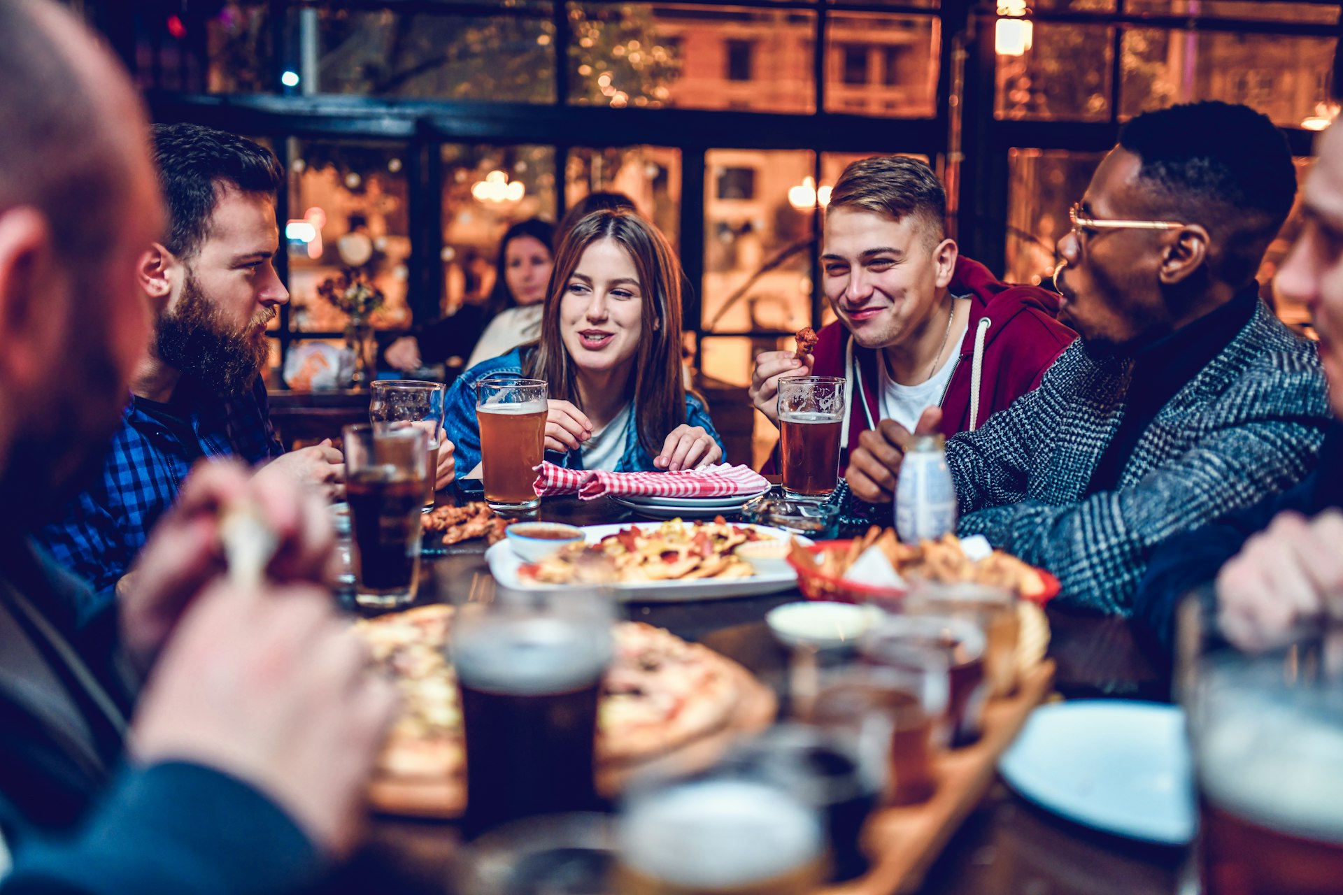 A group of friends enjoy a pizza dinner