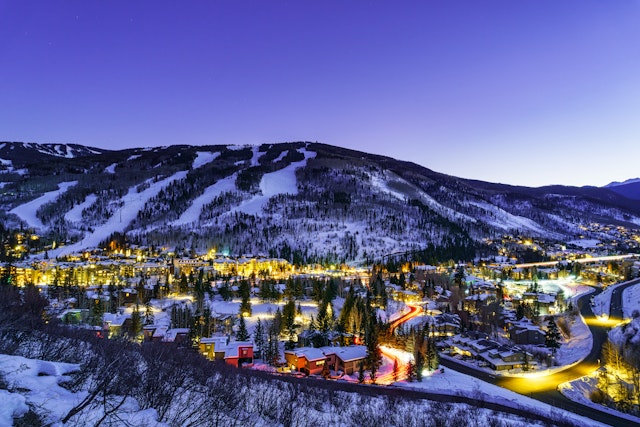 Vail Village and Lionshead Colorado Night View - Town of Vail, Colorado lit up at night in winter with ski runs on mountain above. Scenic landscape of one of Colorado's premier ski resorts.
1379760753