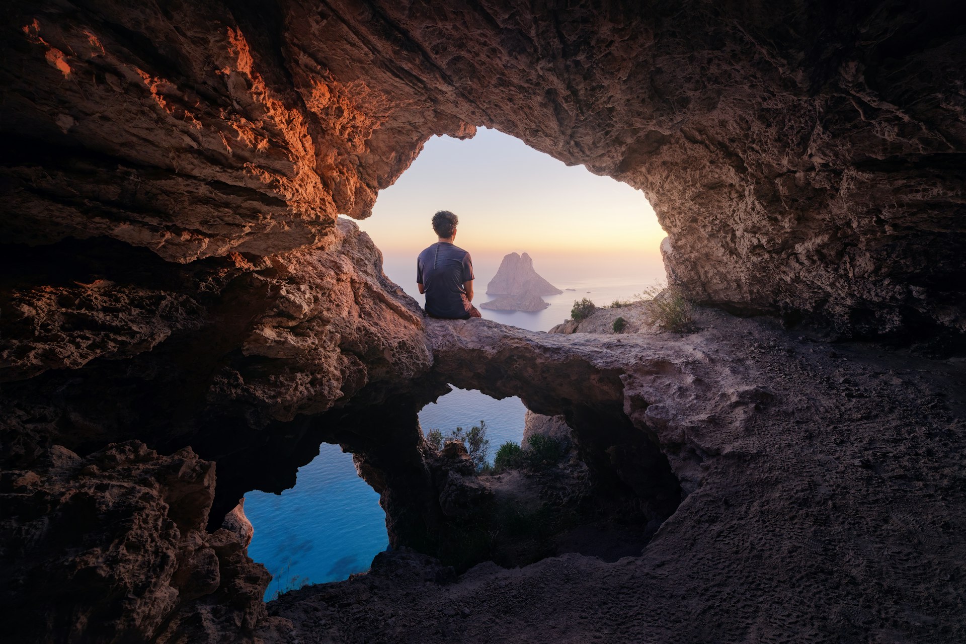 Enjoying the sunset from a cave on the island of Es Vedra, Ibiza