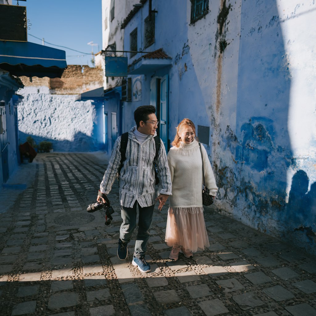Asian Chinese tourist couple walking in alley of Chefchaouen, Morocco
1445105036
A couple walks through the blue city of Morocco.