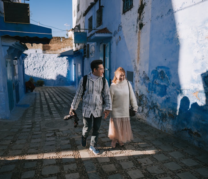 Asian Chinese tourist couple walking in alley of Chefchaouen, Morocco
1445105036
A couple walks through the blue city of Morocco.