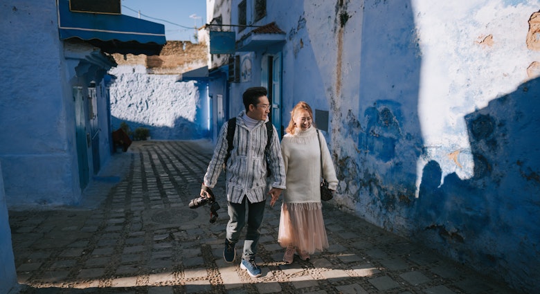 Asian Chinese tourist couple walking in alley of Chefchaouen, Morocco
1445105036
A couple walks through the blue city of Morocco.