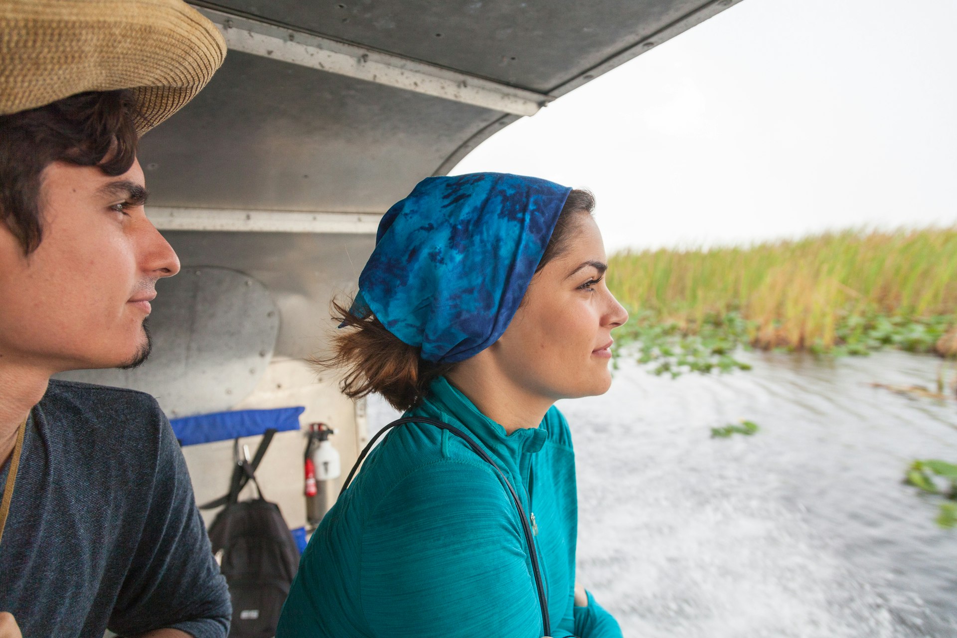 Young couple riding on airboat at the Everglades National Park, Florida, USA